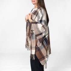 Need something to add to your wardrobe? Our Savannah poncho is just that! A perfect addition to any outfit and a quick grab to keep you nice and warm. Features: 100% acrylic 49" x 57" and 4" fringe on each end Open front oversized plaid poncho with twill weave and fringe at ends Oversized Shawl Cape For Fall, Oversized Cape Wraps For Fall, One Size Fall Cape With Scarf, One Size Woven Poncho Shawl, Oversized Fringe Cape For Fall, Fringe Cape Poncho For Fall, One Size Fall Cape With Scarf Detail, Fringe Poncho Cape For Fall, Fringe Shawl Cape For Fall