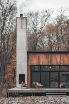 a modern house in the woods surrounded by trees