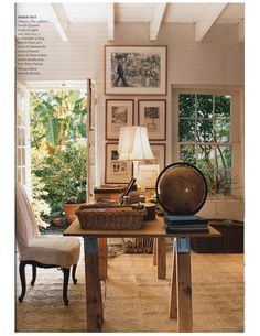 a living room filled with furniture and pictures on the wall