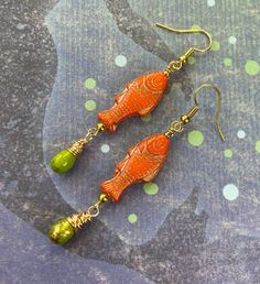 These fun, bright orange fish are Czech glass beads. They have a gold wash that highlights all their cool details. I added lime green Czech glass teardrops to dangle from the bottoms. Hooks are 18k gold plated brass. Lever back hooks are available upon request. Fresh catch earrings are a fun gift for the ocean lover on your list. Vivid and playful, these fish earrings are a great accessory for summer. All of my earrings come on a hand stamped earring card and are lovingly wrapped in colorful tis Coastal Jewelry, Stamped Earrings, Fish Earrings, Orange Fish, Earrings Beach, Beach Earrings, Earring Card, Jewelry Summer