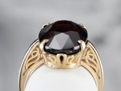 This beautifully structured, classic mounting holds a bold stone! This gem is a gorgeous deep red garnet, weighing in at over 11 carats. Garnets are known for their exceptional color and play of light, and this gem is opulent and sophisticated. Metal: 14K Yellow Gold Gem: Garnet 11.43 Carats Gem Measurements: 11 x 15 mm, Oval Ring Size: 6 Marks: "14K" Stamped on the inside band Luxury Solitaire Ruby Ring For Formal Occasions, Luxury Solitaire Ruby Ring For Formal Events, Pyrope Garnet, Garnet And Gold, Gold Statement Ring, Oval Ring, Oval Rings, Red Garnet, Deep Red