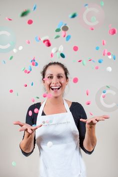 a woman in an apron is surrounded by confetti