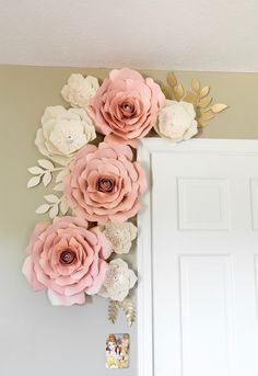 some paper flowers are hanging on the wall