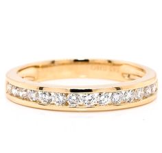 a yellow gold wedding band with five diamonds