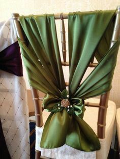 the back of a chair with green sashes on it