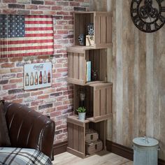 a living room filled with furniture and an american flag on the brick wall behind it