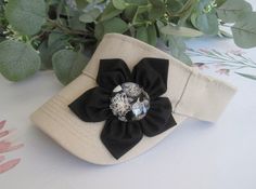 ALL ORDERS TOTALING OVER $35 SHIP FREE I designed this Tan Visor with a black petal flower and Round Glass Cabochon flower accent in the center.  Visor has velcro back See more hats and visor here: https://www.etsy.com/shop/theraggedyrose?ref=seller-platform-mcnav&section_id=10557807 Custom orders alway welcome. Thanks for visiting my shop. Adjustable Flower Hat As A Gift, Golf Visor, Womens Visor, Hats Summer, Summer Hats For Women, Amy Jackson, Petal Flower, Women's Hats, Visor Hats