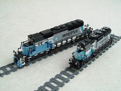 two lego trains sitting side by side on top of each other in front of a white background