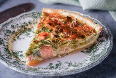 a piece of quiche on a green and white plate