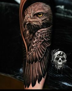 an eagle tattoo on the arm with a skull