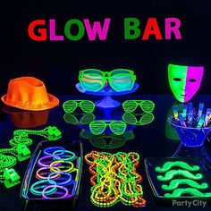 glow party supplies including neon glasses, masks and bracelets on a black table with the words glow bar