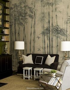 a living room filled with furniture next to a wall covered in bamboo tree murals on the walls