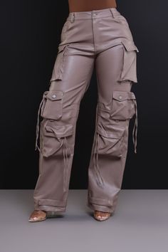 55% Polyester, 45% Polyurethane | Inseam: 34" | Model Wearing A Size Small | Runs True To Size Stay undefeated when you step out in these stylish cargo pants featuring a high rise waist, zippered closure with belt loops, and a wide-leg fit adorned with multiple-sized cargo pockets in soft faux leather. Pants With Lots Of Pockets, Leather Cargo Pants, Ankara Long Gown Styles, Boutique Style Outfits, Faux Leather Pants, How To Make Clothes, Cargo Pants, Trousers Women