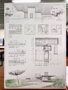 an architectural drawing is displayed in front of a table with papers and laptops on it