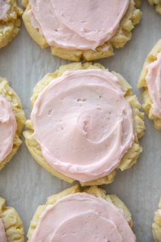 some cookies with pink frosting on top of them