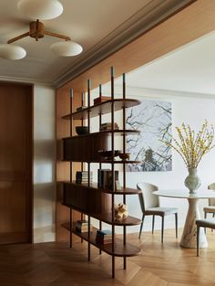 a dining room with wooden floors and shelves