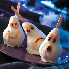 three little white ghost bunnies on a plate with toothpicks in the shape of ghosts