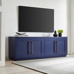 a large flat screen tv mounted to the side of a blue cabinet in a living room