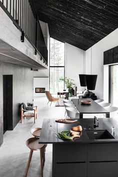 an open kitchen and living room with high ceilings