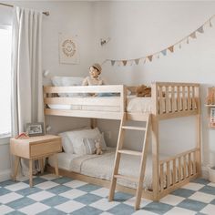 a child's bedroom with two bunk beds and a checkered rug on the floor