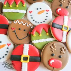 many decorated cookies are arranged in the shape of santa clause