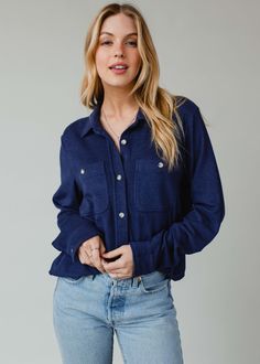 The perfect button up for the season ahead! This super soft button up shirt will be a versatile addition to your wardrobe to dress up or down.  Navy super soft button up top Long sleeves Two front pockets at the bust Button closure on the front Designed in the U.S.A. Produced in China. Model is wearing a size small  75% Rayon / 15% Acrylic / 10% Spandex SIZE CHART S: Bust: 40" / Length: 24.5" M: Bust: 42" / Length: 25.5" L: Bust: 44" / Length: 26.5" XL: Bust: 46" / Length: 27.5" Cheap Blue Button-up Outerwear, Cheap Blue Button-up Jeans, Affordable Washed Blue Button-up Jeans, Cheap Button-up Denim Jeans, Cheap Button-up Tops With Covered Buttons, Affordable Light Indigo Button-up Shirt, Affordable Snap Button Button-up Tops, Button Ups, Blouse Tank Top