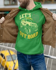 a man wearing a green hoodie with a jeep on it and let's go off road