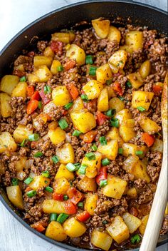 a skillet filled with ground beef and potatoes