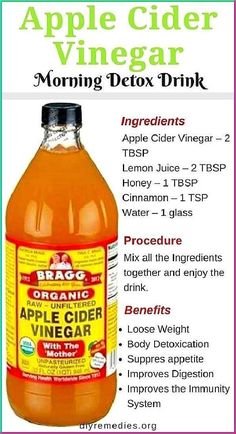 a bottle of apple cider vinegar sitting on top of a table