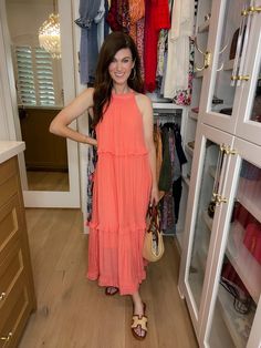 Get ready to dream of summer in our Summer Dream Maxi Dress! Made with lightweight, airy fabric, this gorgeous coral dress has that effortless feel and features a tiered body with ruffle trim. Add a slicked back ponytail or bun and pair with sandals or wedges for the perfect summer look. Carefree, chic, and easy - it's the perfect summer dress! This if fully lined. Strap length can be adjusted in the back. Dress measures 53" in length. Bust measures 22" from underarm seam to seam. Measurements taken on a small. Fabric has some give. This has a generous fit. Your normal size will be roomy throughout. If in between sizes or wanting a less loose fit, size down. Be sure to watch the fit video on the app for more information. FABRIC: 100% poly Heather is a 4 and 5'6" wearing a small. Back Ponytail, Fit Video, Slicked Back Ponytail, Casual Chic Spring, Coral Dress, Summer Dream, Summer Look, Hat Hairstyles, Ruffle Trim