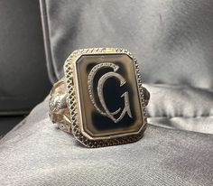 A beautiful 1900s German one-of-a-kind handmade signet ring with a beautiful semi-transparent agate stone and an inlaid monogram (initials 'GC'). Hallmarked 830 silver. On the ring shoulder application of a warrior (Roman or knight with spear) and a defense tower, US Size 8 1/2, in good antique condition, would make a nice gift for someone special! The ring was professionally cleaned by a jeweler! Material: solid silver, agate Weight: 12 g US Size: approx. 8 1/2 (EU 59) PLEASE LOOK AT THE PICTURES, THEY ARE PART OF THE DESCRIPTION AND ARE THE ACTUAL ITEM YOU WILL RECEIVE. Antique Agate Intaglio Jewelry, Vintage Agate Rings For Anniversary, Knight With Spear, Ring With Initials, Signet Ring Silver, Signet Ring Men, Blue Stain, Star Top, Agate Ring