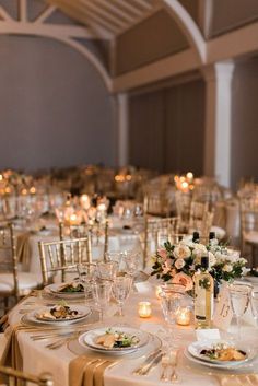 the tables are set with white and gold linens for an elegant wedding reception at the grand america hotel