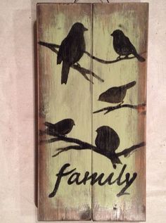 a wooden sign with birds on it that says family