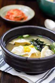 a bowl filled with soup on top of a wooden table