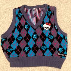 A Black, And Blue V-Neck Sweater Vest Exclusive From Spirit Halloween In A Collaboration With Monster High. Listed As A Large As Seen On Tag, However It Is Cropped. Never Worn. No Tags. No Stains. No Tears. Has A White Skull With Bow Decal On Left Side. Casual V-neck Halloween Tops, Stein Cosplay, Skull With Bow, Monster High Costume, Monster High Clothes, Chirstmas Gift, Frankie Stein, Halloween 2022, Halloween Monster