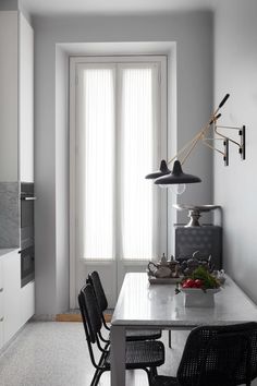 a dining room table and chairs in front of a window