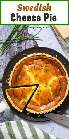 a cheese pie on a black plate with a green and white striped napkin next to it