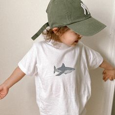 "Hey! Thanks for stopping by my shop. This listing is for an Embroidered great white shark bella + canvas toddler t-shirt. This is an original design shark toddler size shirt. Perfect for your little one or makes a great gift for other mamas for their toddlers. This baby shark toddler tee is part of my \"Kid+Toddler+Baby Shirts\" collection. If you're interested in a matching parent crewneck pullover sweatshirt see my other listing here: https://www.etsy.com/listing/1519424672/embroidered-great-white-shark-crewneck. This embroidered great white shark toddler t-shirt is made especially for you as soon as you place an order, which is why it takes us a bit longer to deliver it to you. Making products on demand instead of in bulk helps reduce overproduction, so thank you for making thoughtful Cotton T-shirt With Shark Design For Summer, Family Matching White T-shirt For Beach, Casual Cotton T-shirt With Shark Design, Summer Short Sleeve T-shirt With Shark Design, Casual Short Sleeve Shark Design Tops, Casual Short Sleeve T-shirt With Shark Design, Casual Short Sleeve Top With Shark Design, Casual Summer T-shirt With Shark Design, White Crew Neck Top With Shark Design