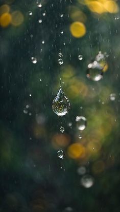 drops of water hanging from a window in the rain