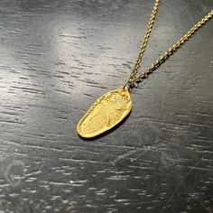 This design features my carved Reversible Feather in Gold! These pendants are made with GOLD VERMEIL! GOLD VERMEIL is a premier version of a thick electro-plating of 23.5 karat Gold over a solid Sterling Silver base- it's the right solution for us to provide everyone who wants their 永 pieces in GOLD that are durable, beautiful, and affordable! Still, we recommend that you wear these pieces gently and thoughtfully. The Vermeil is a surface finish after all, and although these pieces are quite sta Artisan Yellow Gold Medallion Jewelry, 22k Gold Engraved Medallion Jewelry, Engraved 22k Gold Medallion Jewelry, Artisan Yellow Gold Medallion Necklace, Luxury Gold Necklace With Oval Pendant, Artisan Oval Gold Jewelry, Artisan Engraved Yellow Gold Necklace, Luxury Gold Oval Pendant Necklace, Gold Oval Brass Necklaces