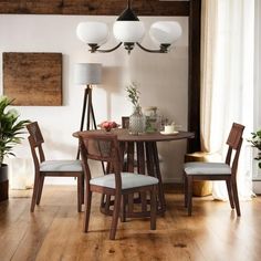 a dining room table and chairs with white cushions