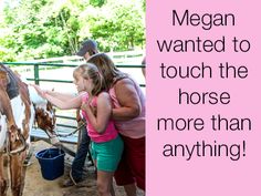 a woman and child petting a horse on the nose while another girl looks on