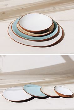 four plates stacked on top of each other in different shapes and sizes, all with gold rims