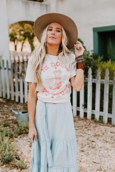 In Dolly We Trust Tee is every country western girl's motto! Pink graphic on an ivory tee make it easy to match with maxi skirts and jeans! *Due to lighting and differences in monitors, actual colors may vary slightly from what appears online. Model is 5'8" and wearing a size Small. Approximate measurements are as follows: SMALL: Bust: 33", Length: 27", Sleeve length: 7.5 " MEDIUM: Bust: 35", Length: 27.5", Sleeve length: 7.5 " LARGE: Bust: 37", Length: 28", Sleeve length: 7.5 " 100% Cotton Mach Country Style T-shirt For Rodeo In Spring, Summer Graphic Print T-shirt For Country Events, Spring Graphic Tee For Rodeo, Spring Rodeo Graphic Tee, Graphic Tee For Rodeo And Spring, White Tops For Country Events In Summer, Fitted Western Style T-shirt For Summer, Country Style T-shirt For Spring Events, Spring Country Style T-shirt For Country Events