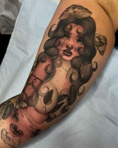 a woman's arm with tattoos on it