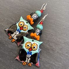 "Ahoy Matey!! These spooky little sweeties feature limited edition handmade enamel charms in the shape of little owls dressed up in their Vampire custome, complete with capes and bow ties! On top are ruffled pumpkin orange Lampwork discs and Lampwork rounds in clear with cool black scrollwork... almost looks like spiderwebs! Finished off with aqua Czech glass and blood red dots at the top. **One of a Kind, using limited edition components* Suspended from Sterling earwires. Length 2 1/2\" includi Playful Enamel Nickel Free Earrings, Playful Enamel Earrings Nickel Free, Fun Enamel Earrings For Gifts, Playful Black Earrings For Gift, Whimsical Enamel Earrings Nickel Free, Cute Handmade Enamel Earrings, Nickel-free Enamel Jewelry With Fun Style, Nickel-free Enamel Fun Jewelry, Playful Halloween Earrings As A Gift