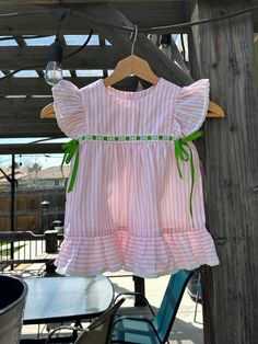 Vintage pink stripe flutter sleeve dress. Size- estimated 3t. please check measurements. Length- 18 in Width- 12 in ptp couple of tiny faint blue spots. see last photo. Striped Ruffle Dress For Playtime, Striped Summer Dress For Playtime, Cute Butterfly Sleeve Beach Dress, Playful Striped Short Sleeve Dress, Striped Spring Dresses For Playtime, Cute Striped Dress For Playtime, Striped Short Sleeve Dress With Ruffles, Striped Dress With Ruffle Sleeves For Spring, Flutter Dress