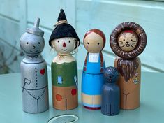 a group of wooden dolls sitting on top of a table