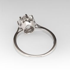 This classic vintage 1950s solitaire ring is crafted of 18k white gold and now holds a 1.01ct lab grown diamond that is IGI certified and grades E in color and VVS2 in clarity. The ring is currently a size 4. EraGem lab diamond rings will arrive with an in-store certification as well as the IGI report and a lovely EraGem logo presentation box. Platinum Diamond Ring With Prong Setting, Classic Platinum Cluster Ring With Vvs Clarity, Platinum Halo Ring With Asscher Cut Brilliant, Classic Cluster Ring With Lab-grown Diamond Cut, Classic Diamond White Cluster Ring For Proposal, Anniversary Platinum Cluster Ring With Center Stone, Asscher Cut Brilliant Cluster Ring For Anniversary, Platinum Cluster Ring With Diamond Cut, Classic White Platinum Cluster Ring