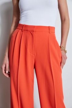 Meet the pant of the season! Our Fluid wide leg Crepe Pant features pleats at the waist and a cuffed hem. Worn with its matching vest or with one of Elie's must have shirts or knits, it is the perfect pant addition to your wardrobe. High Rise Wide Leg Fluid Crepe Pleated Pant Runs true to Size Model is 5'9" and wearing size 2 Dry Clean Only Imported Style #: ETR41359 Summer Workwear Pants With Pleated Waist, Spring Pleated Waist Wide Leg Pants For Workwear, Spring Wide Leg Pants With Pleated Waist For Workwear, Spring Trousers With Accordion Pleats, Summer Workwear Bottoms With Pleated Hem, Formal Summer Bottoms With Pleated Hem, Summer Formal Bottoms With Pleated Hem, Casual Wide Leg Pants With Pressed Crease For Spring, Casual Spring Wide Leg Pants With Pressed Crease